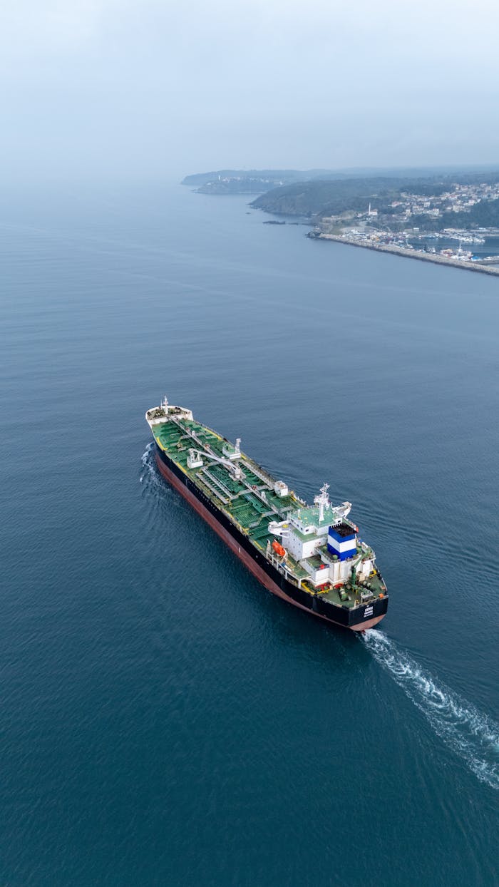 Crafting Captivating Headlines: Your awesome post title goes here Aerial view of a cargo ship sailing near the coastline on a calm day.